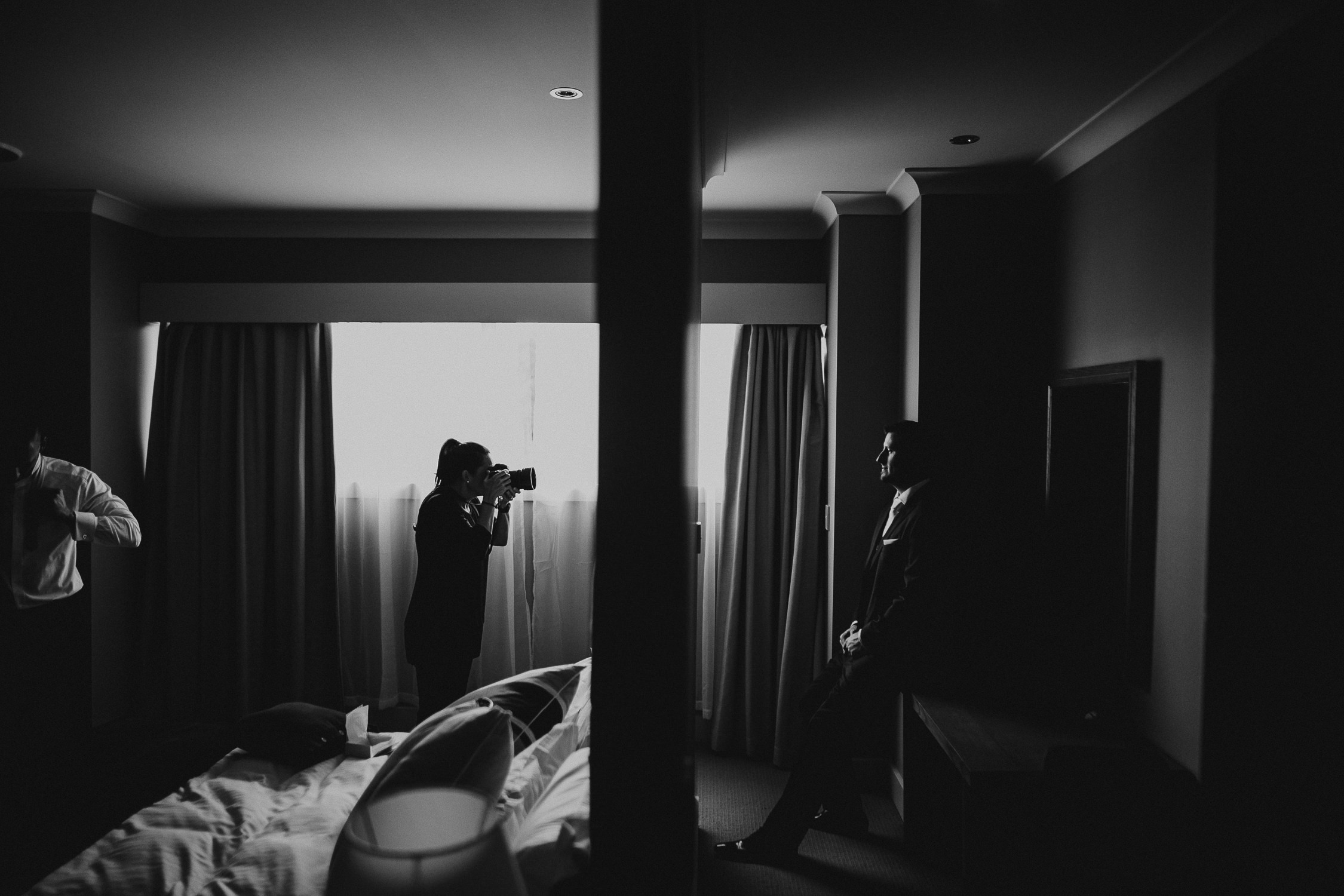 photographer taking photo of groom